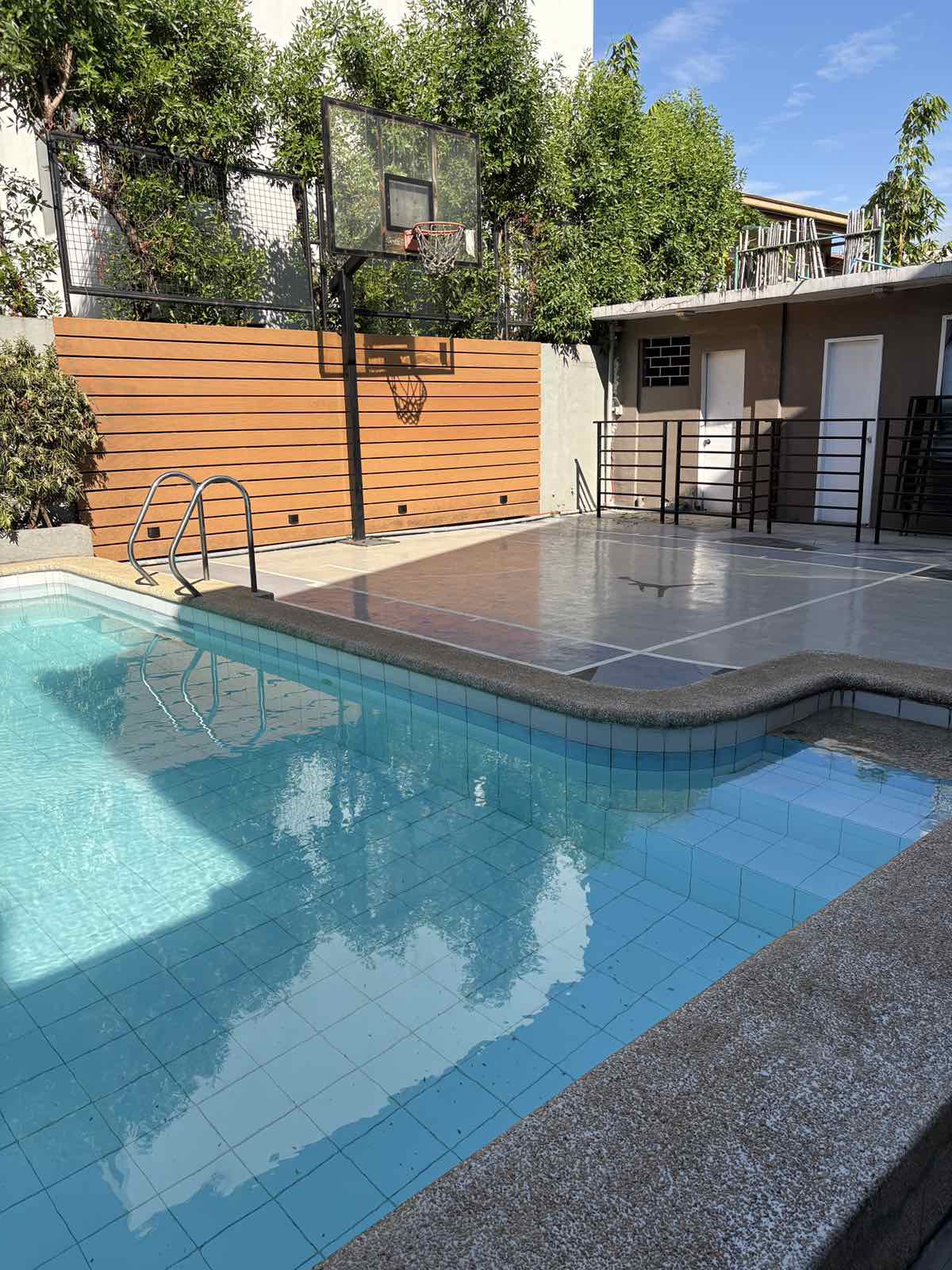 Private swimming pool with the court behind