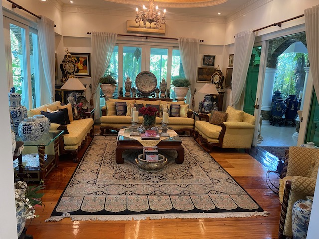 Formal sala with hardwood floors and curated art