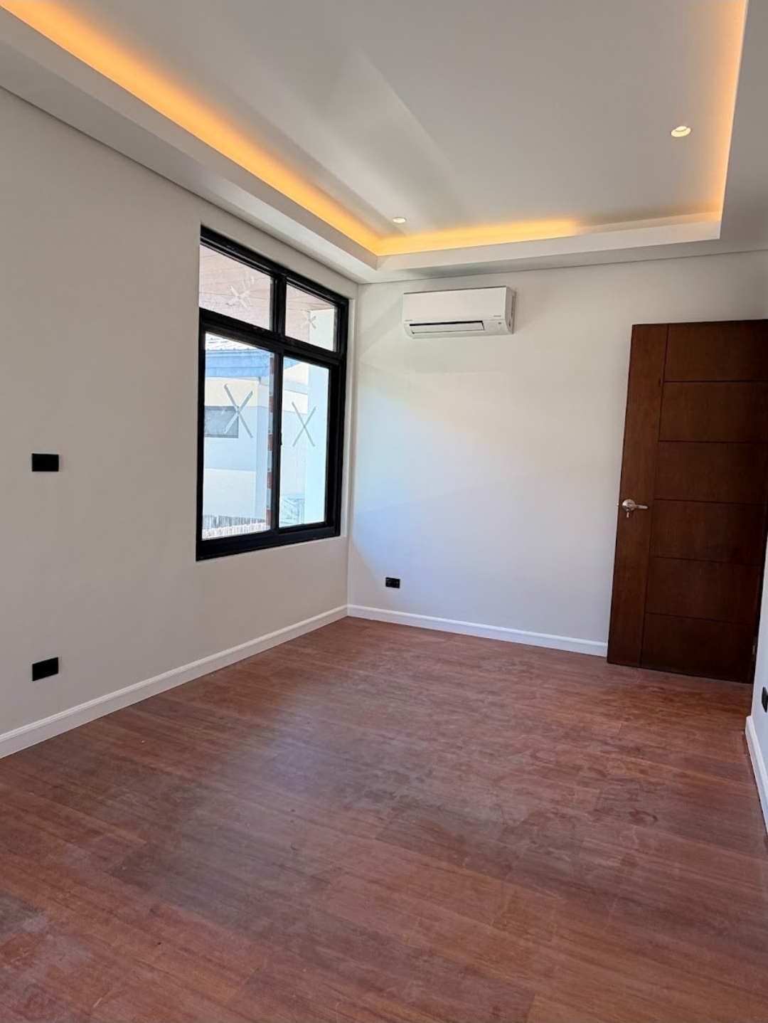 Bedroom with large window and solid wood door