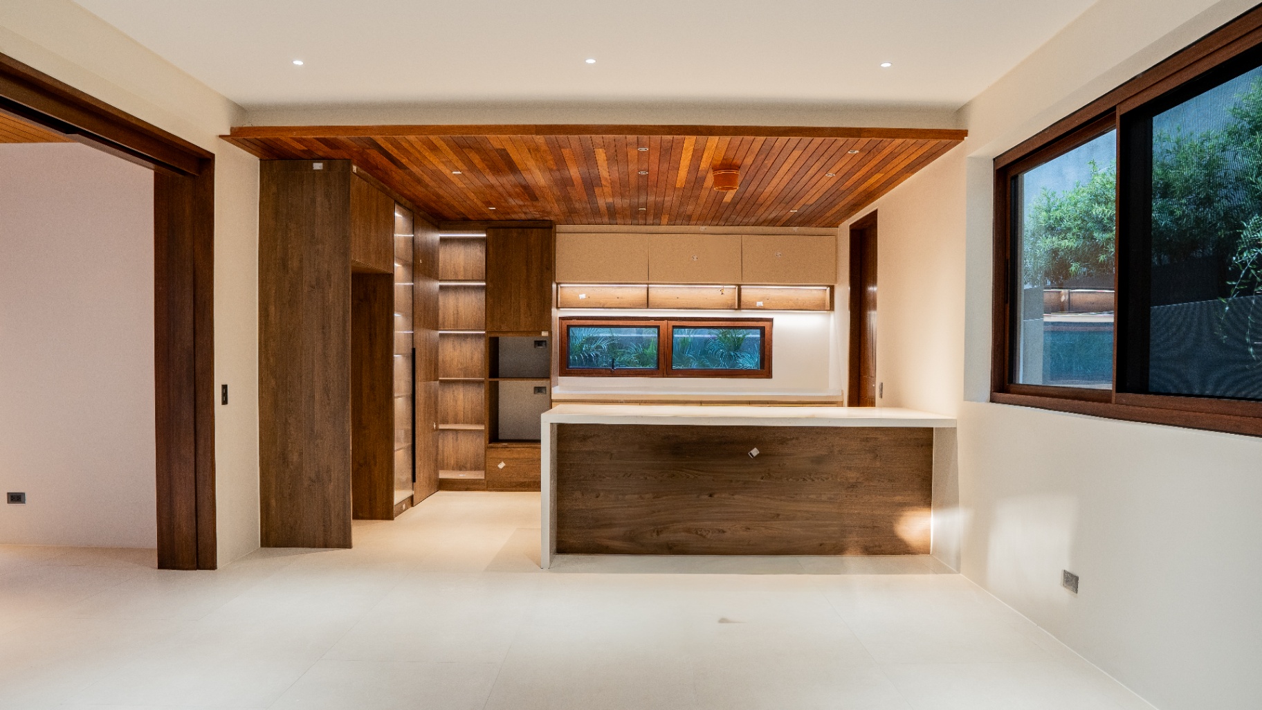 Open plan kitchen with island counter and integrated cabinetry
