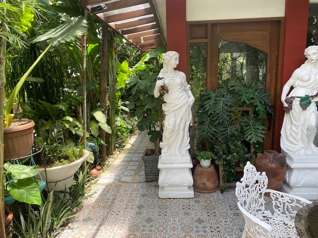 Landscaped garden path with statuary and tropical planting
