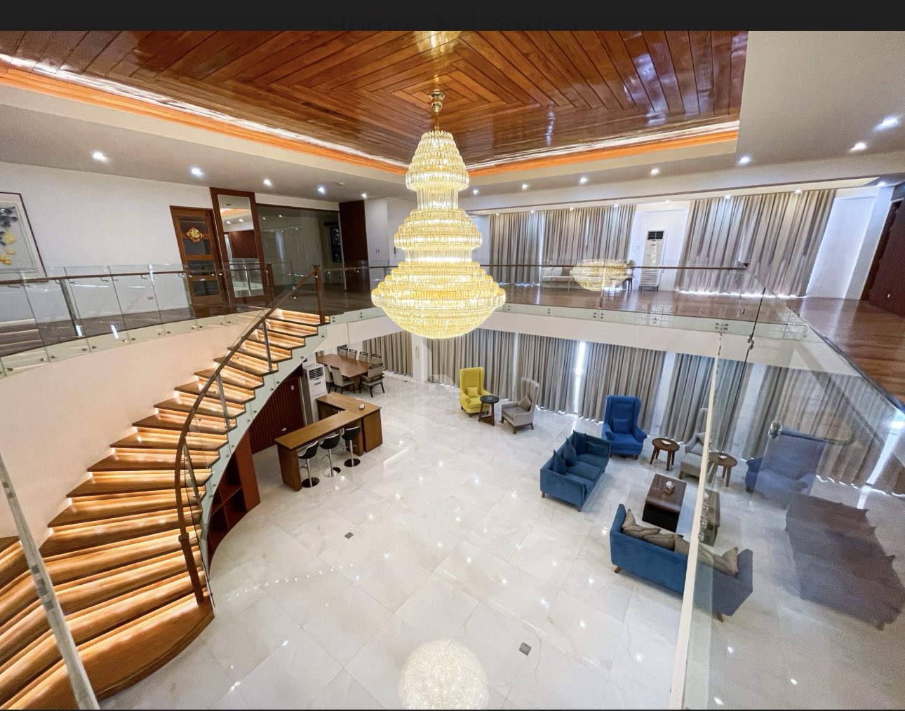 Curved staircase seen from the upper gallery above the living hall