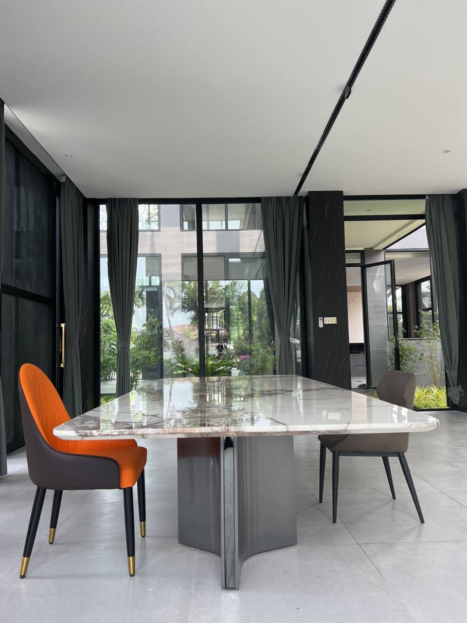 Formal dining area with marble table and designer chairs