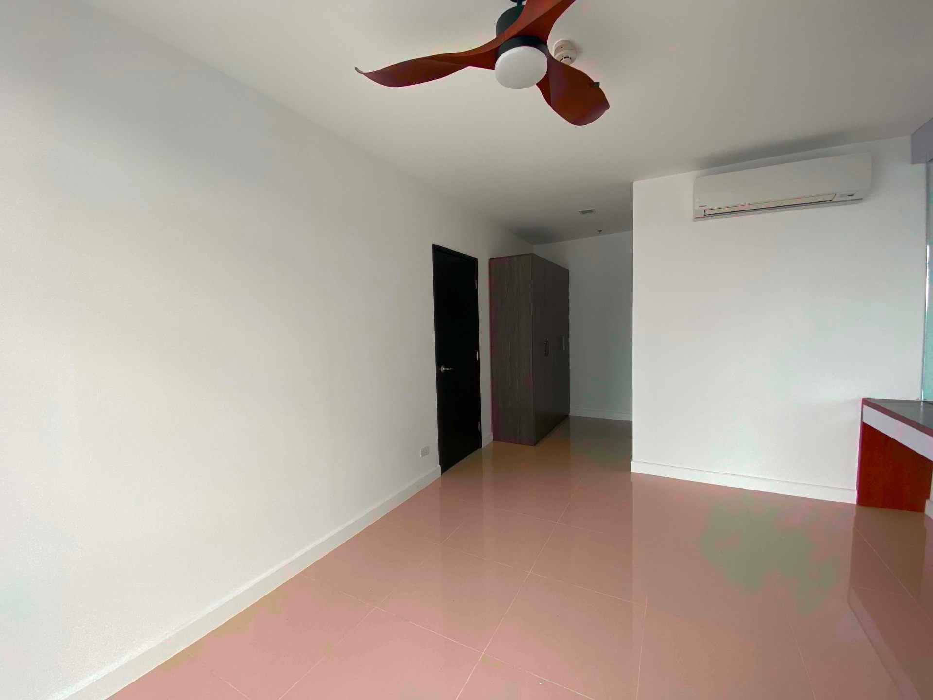 Bedroom with built-in wardrobe, ceiling fan, and study desk