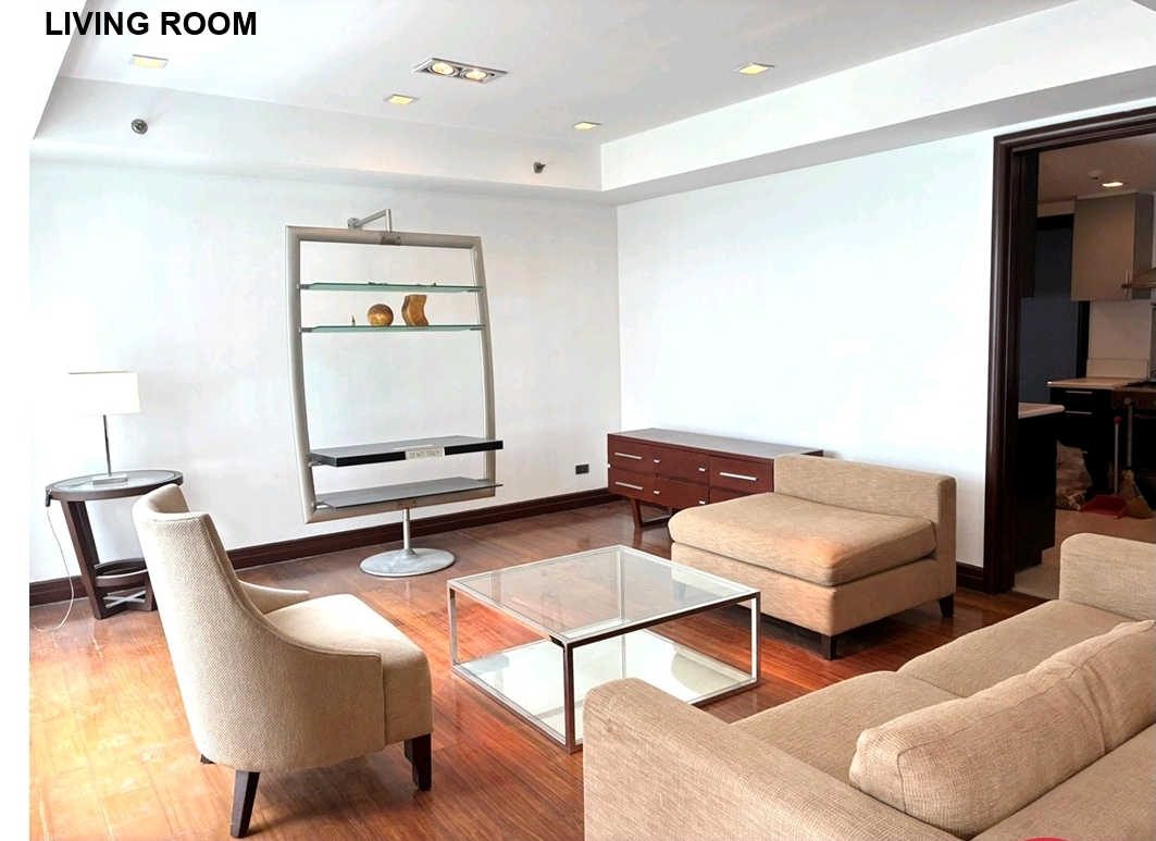 Furnished living room with lounge seating and display shelving