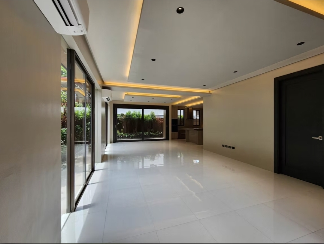 Open living and dining area with cove lighting