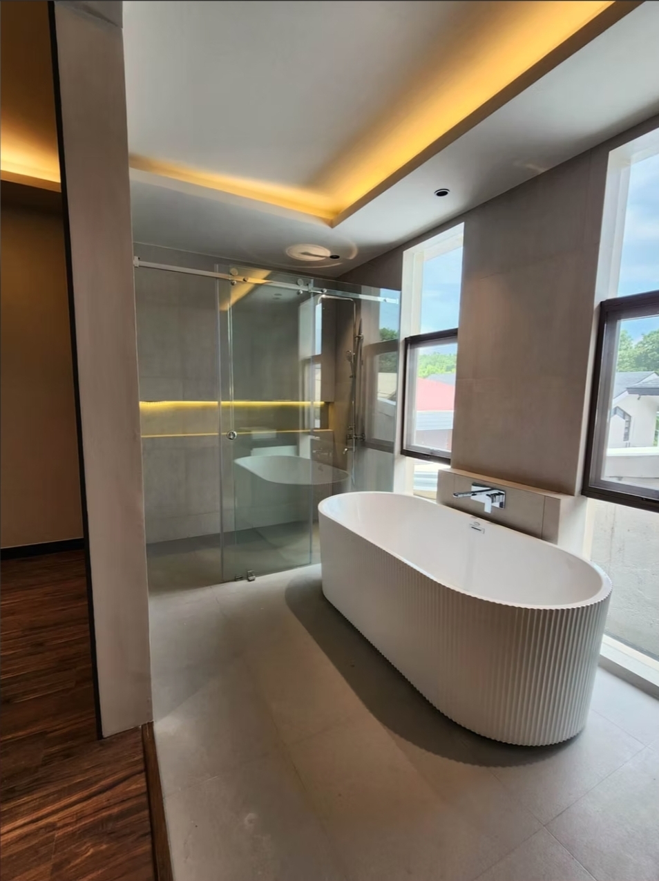 Master bathroom with freestanding tub and rain-shower enclosure