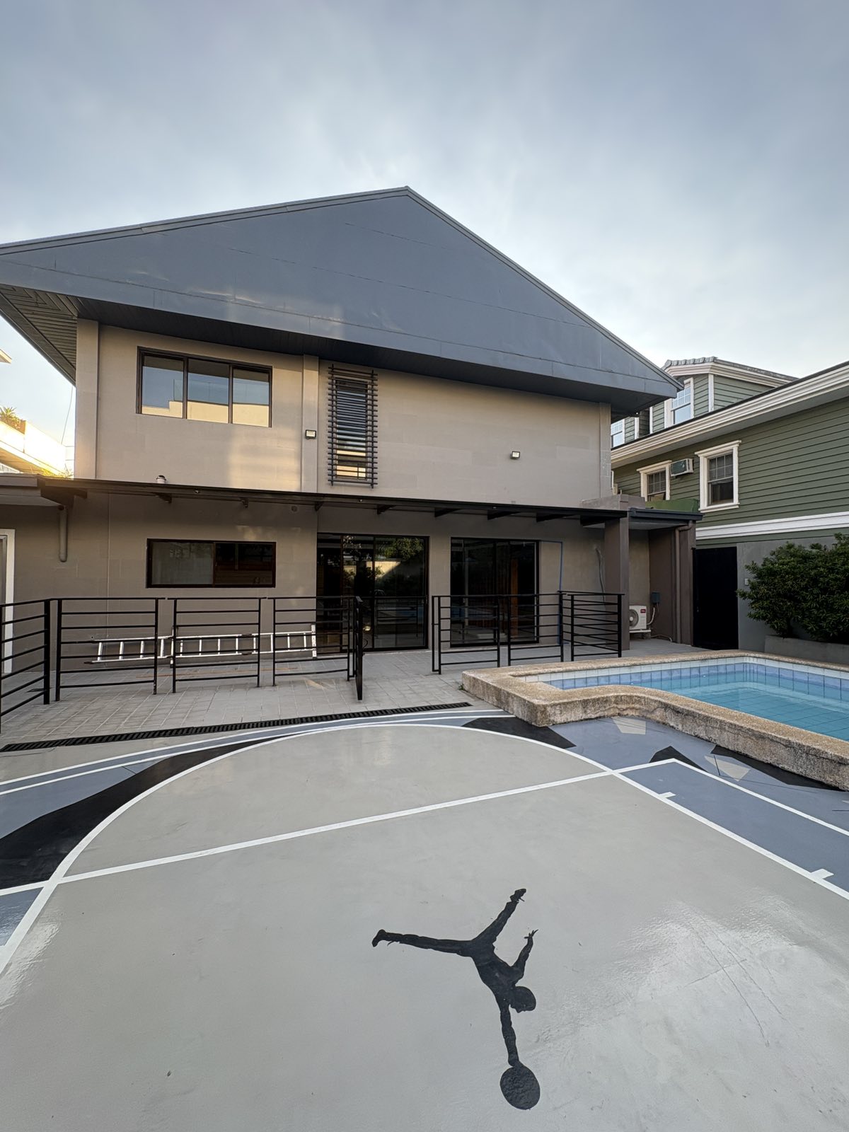 Rear elevation overlooking the pool and basketball court