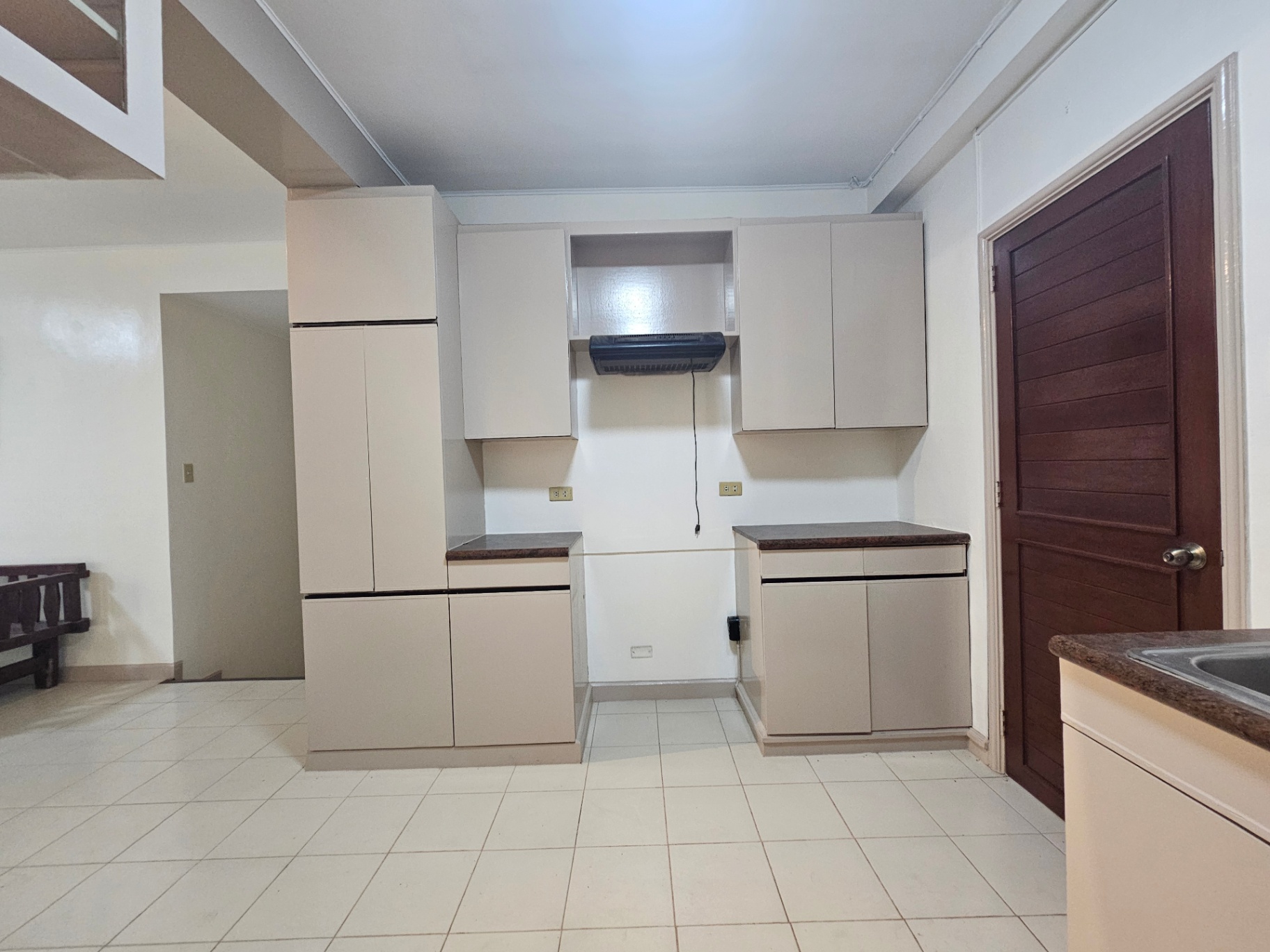 Spacious kitchen with full-height cabinetry and range hood