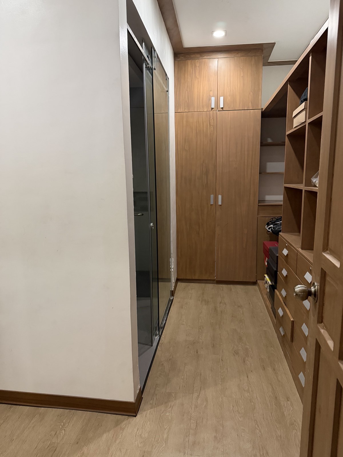 Walk-in dressing room with custom wood cabinetry