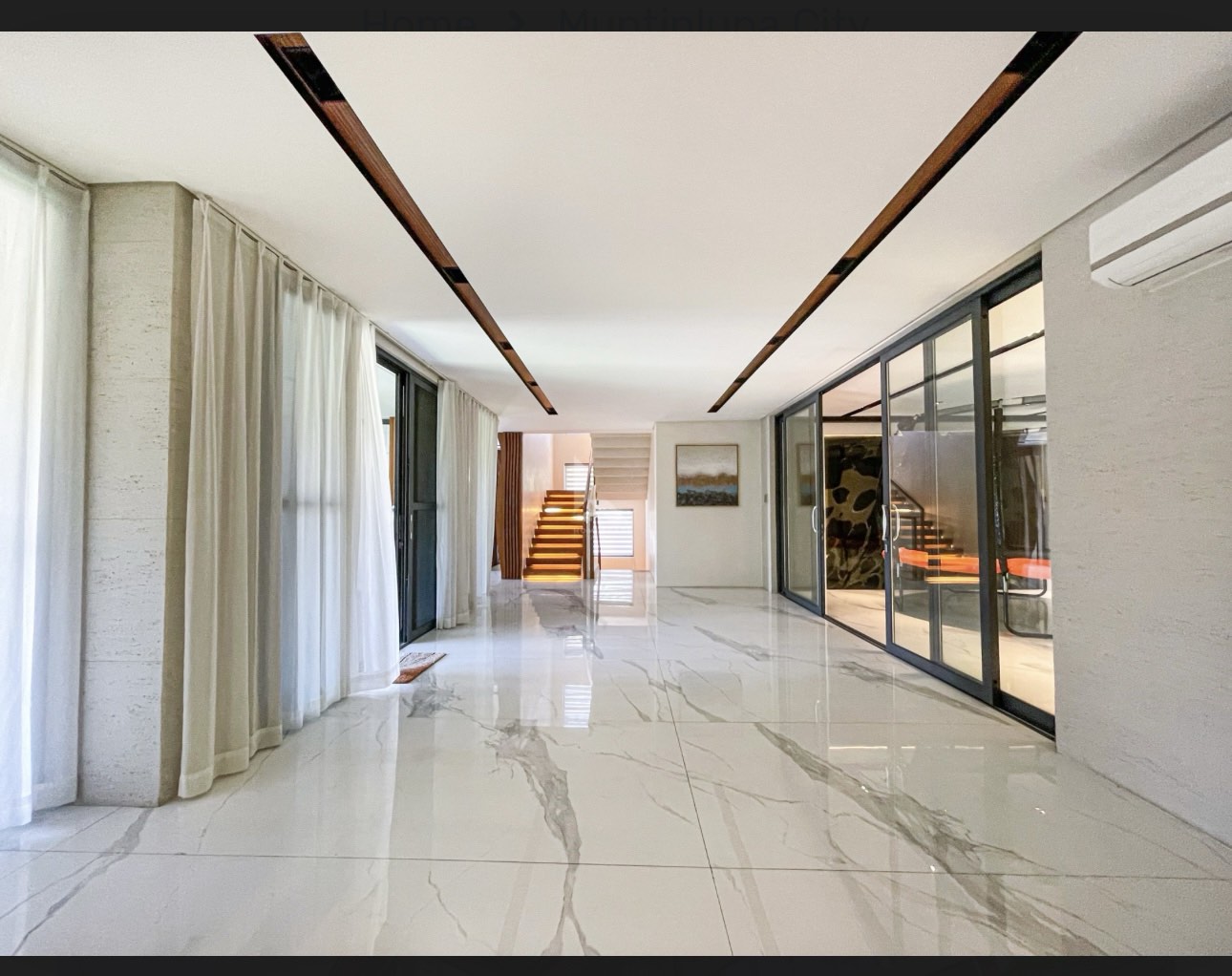 Marble gallery hallway with wood ceiling detail