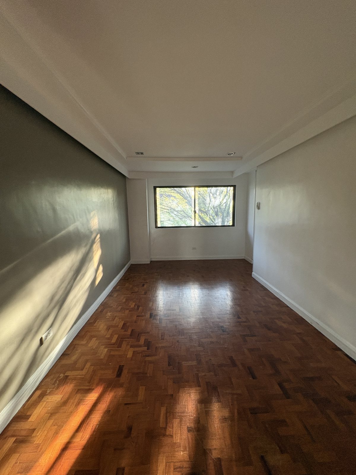 Light-filled room with herringbone parquet floors