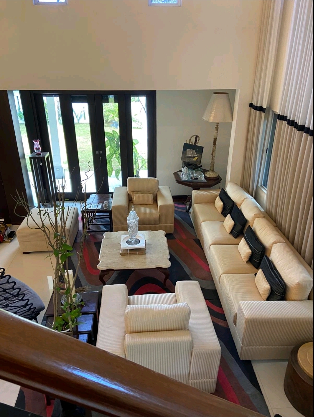 Sunlit lounge with plush sofas overlooking the garden