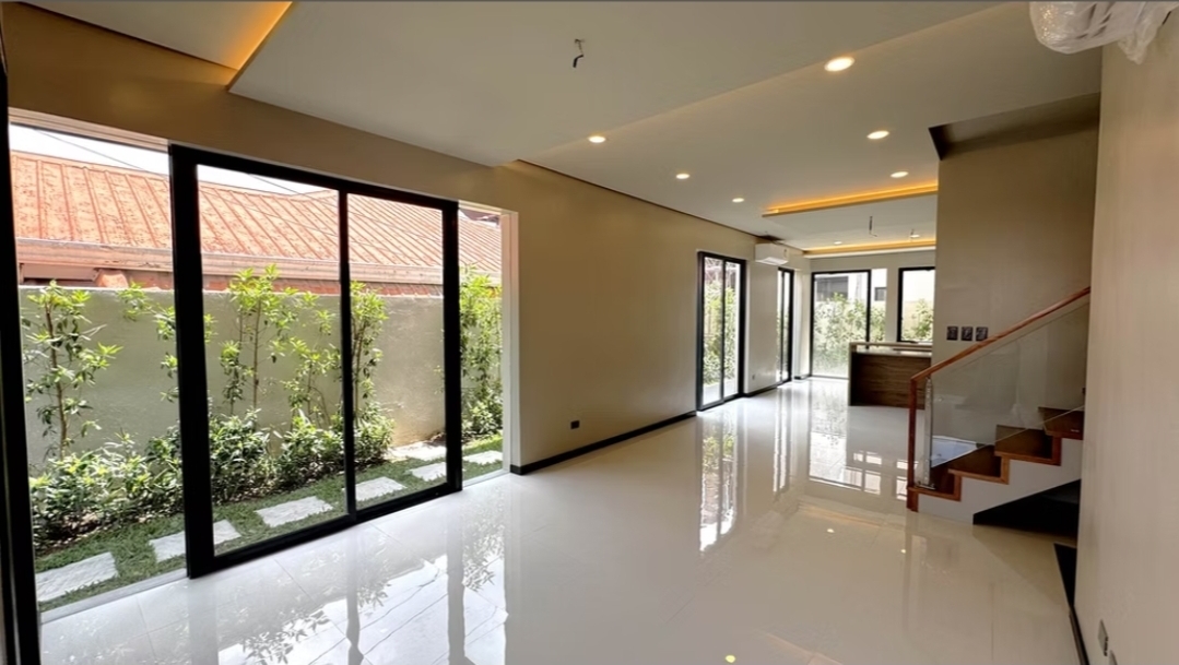 Open living and dining area with cove lighting