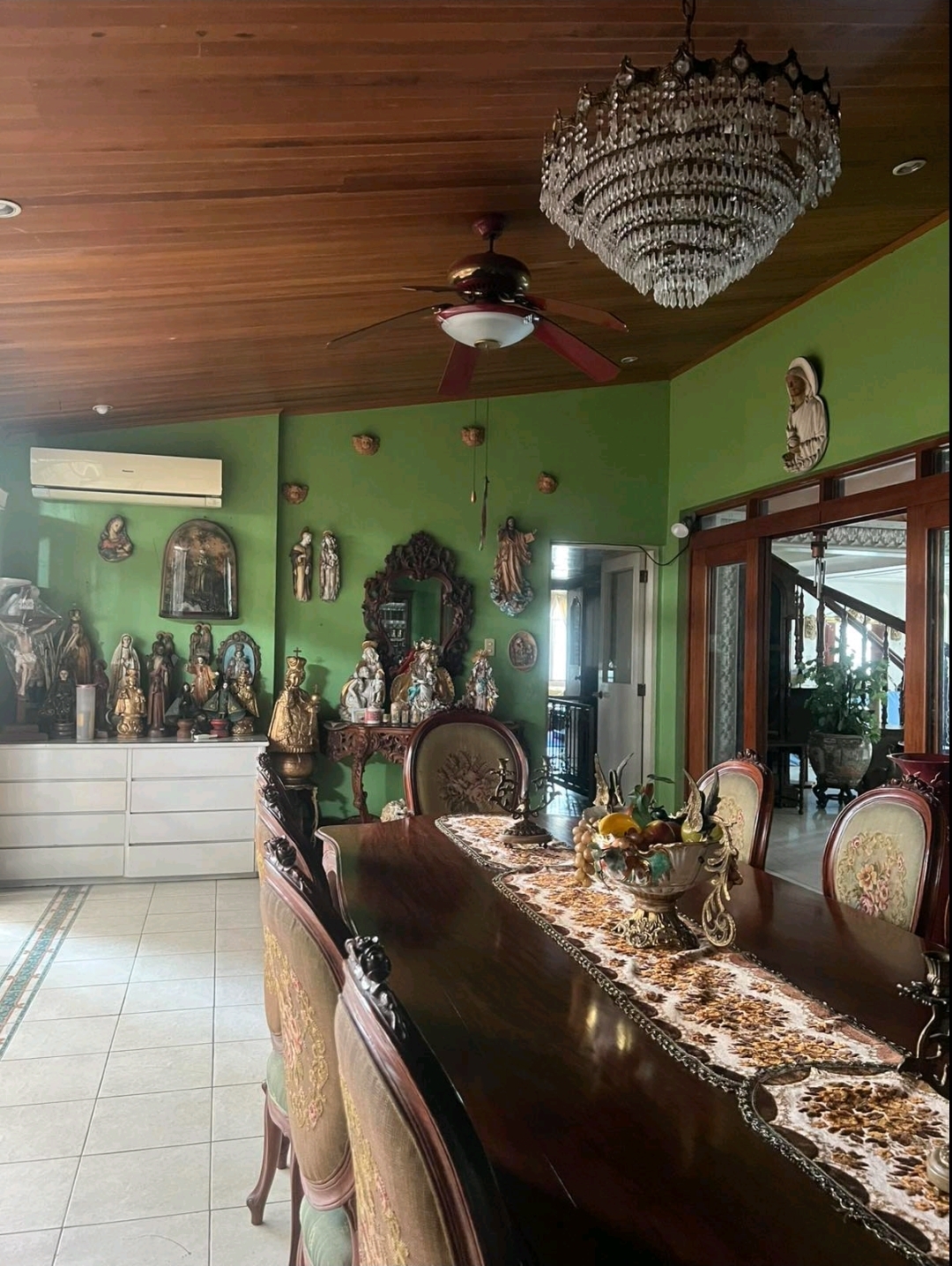 Dining area with antique collection and wood-panelled ceiling