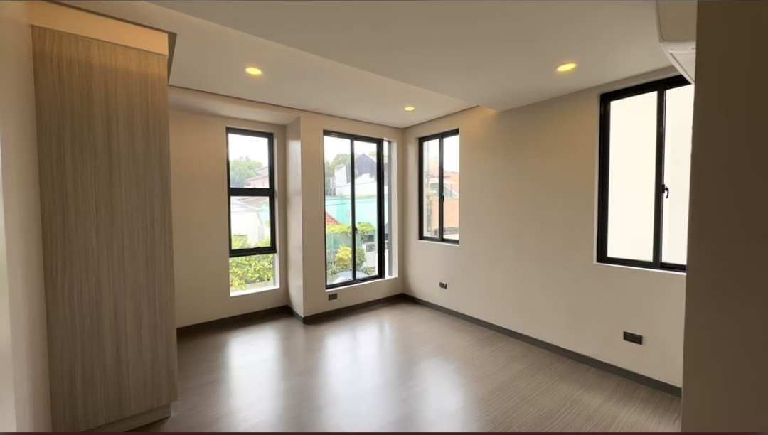 Bedroom with wood flooring and corner picture windows