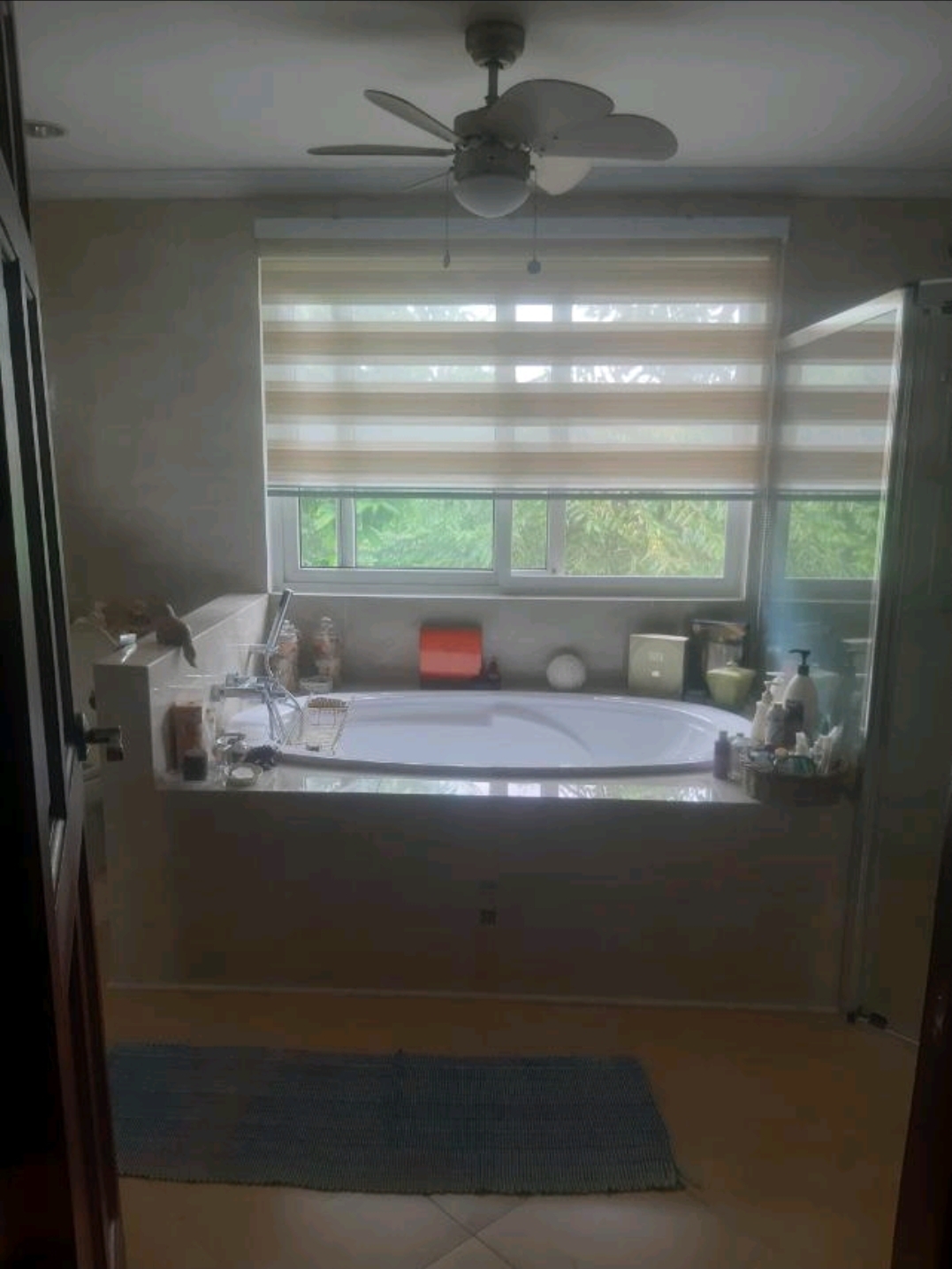 Master bathroom with soaking tub, dual basins and window to garden
