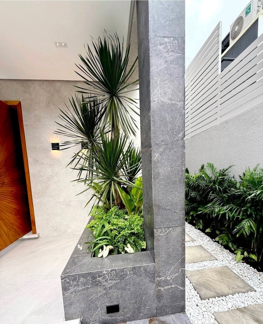 Stone-clad atrium courtyard with sculptural planting