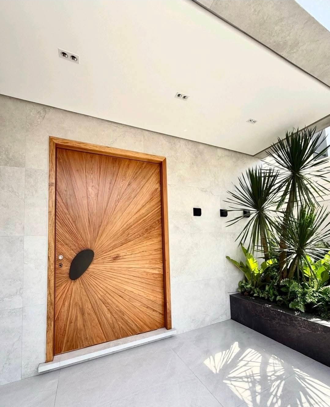 Sunburst-pattern timber pivot entry door