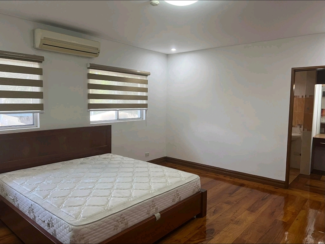 En-suite bedroom with timber floors and private bath