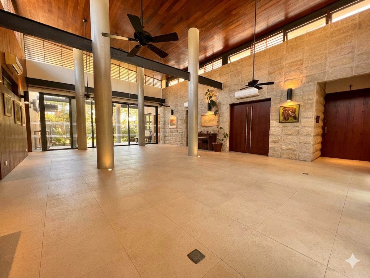 Stone-walled foyer with double-height wood ceiling and gallery lighting