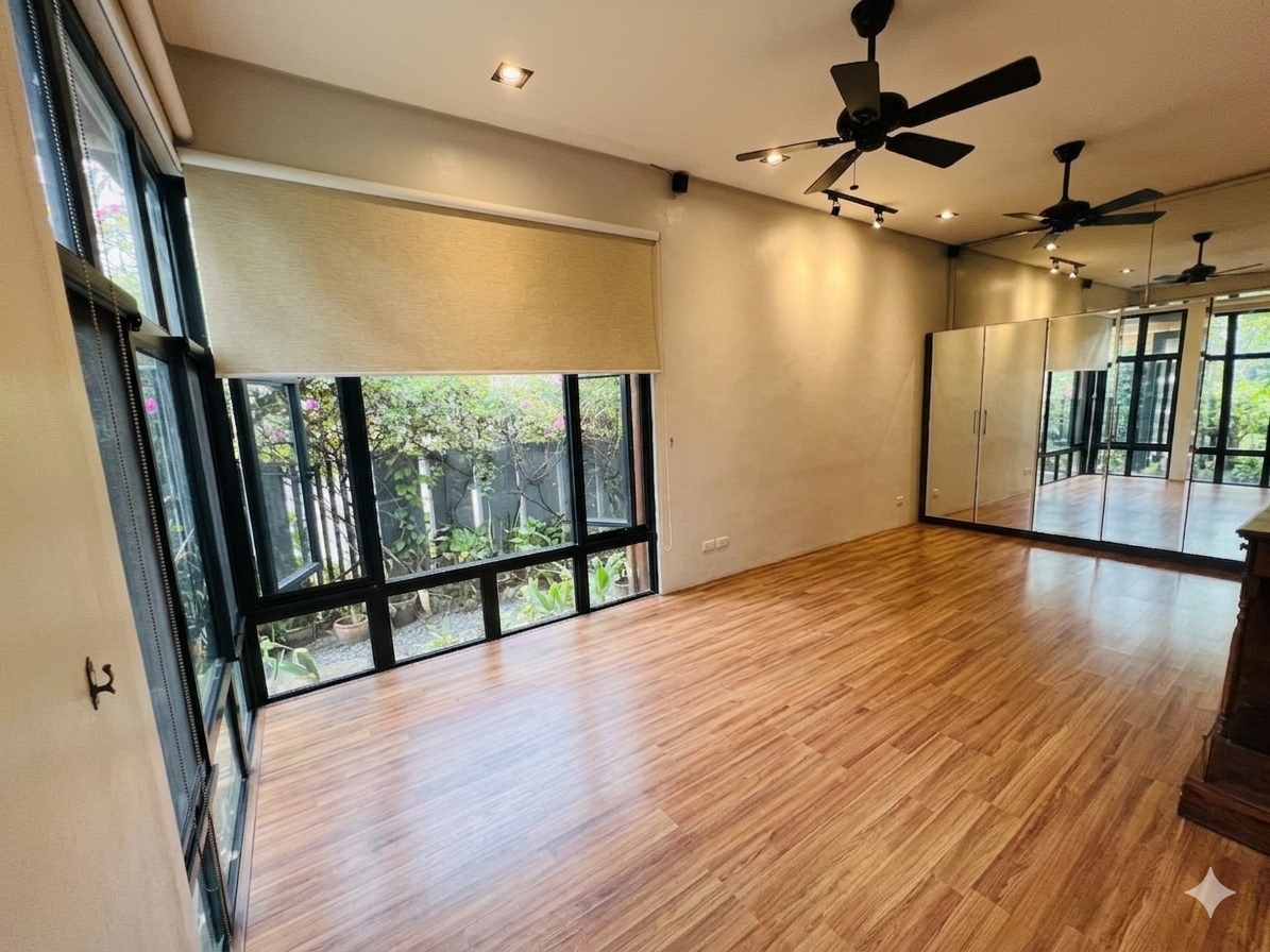 Mirrored gym room with timber flooring and garden-facing windows