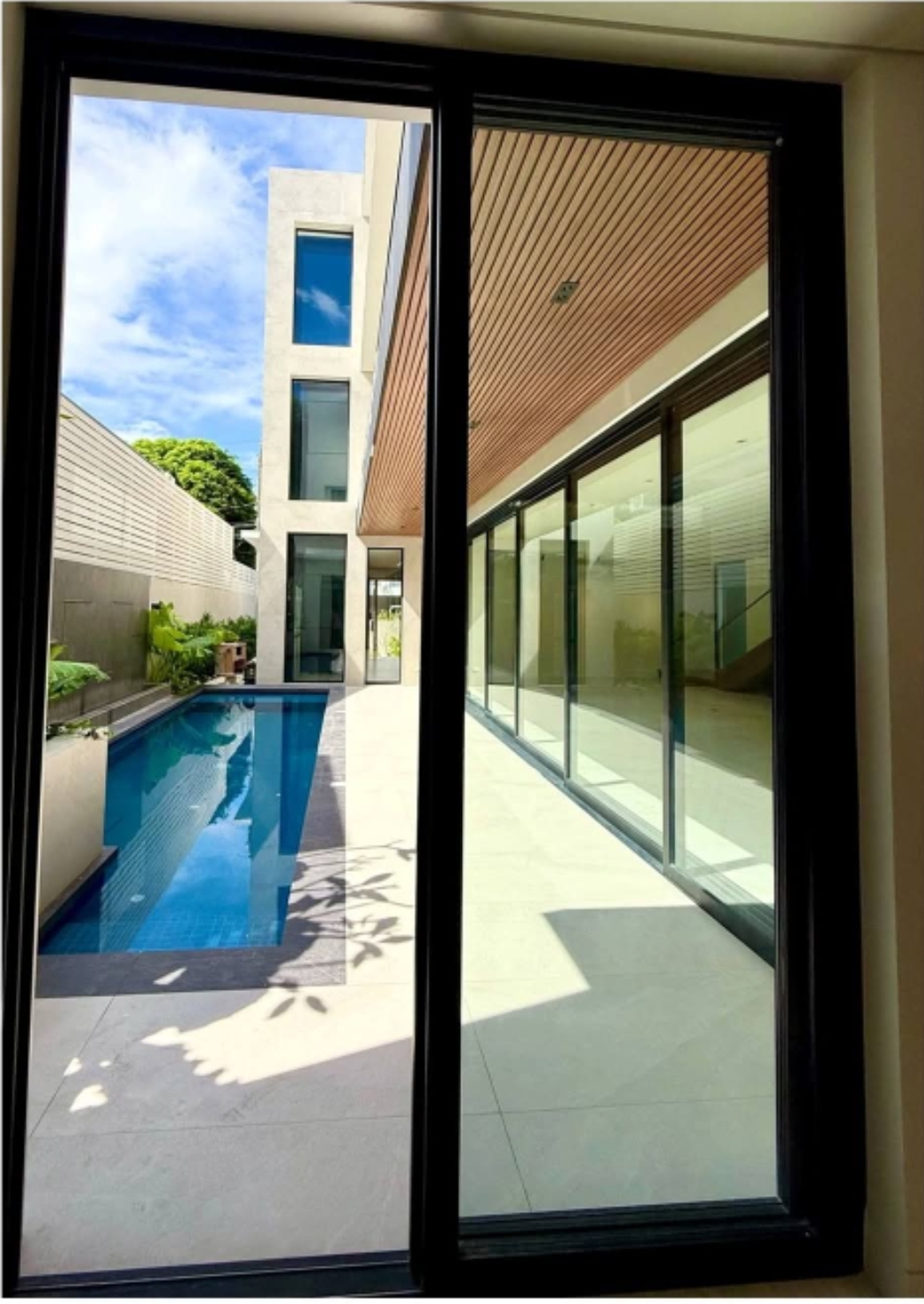 Lap pool framed by full-height sliding glass doors