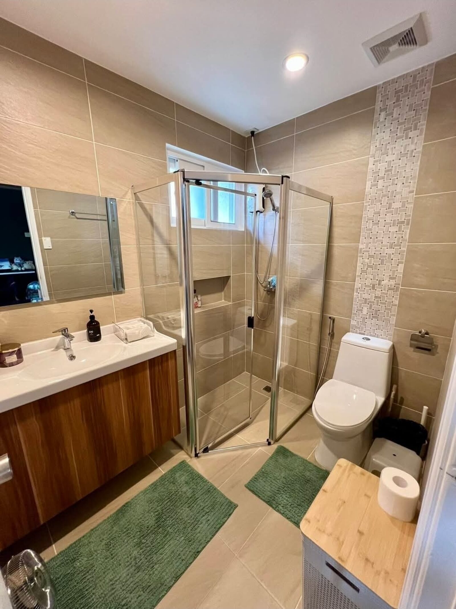 Modern tiled bathroom with glass shower enclosure