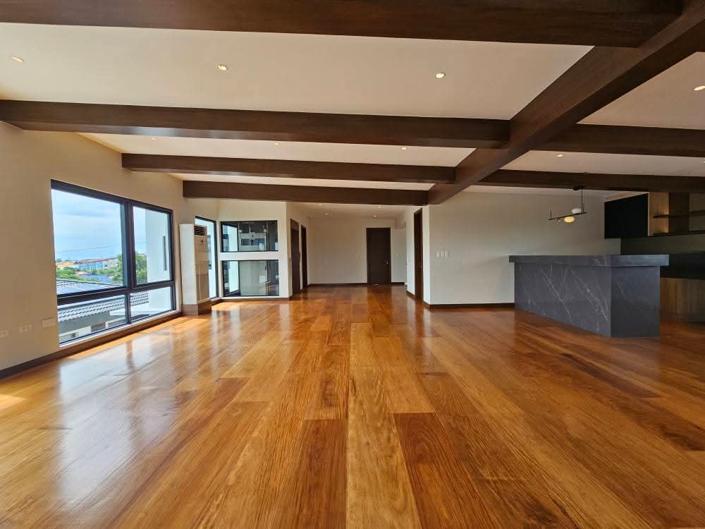 Top-floor entertainment hall with exposed beams and bar