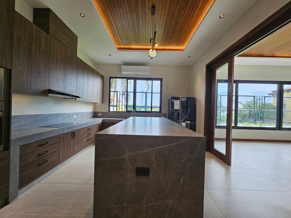 Showcase kitchen with exotic stone island and European cabinetry