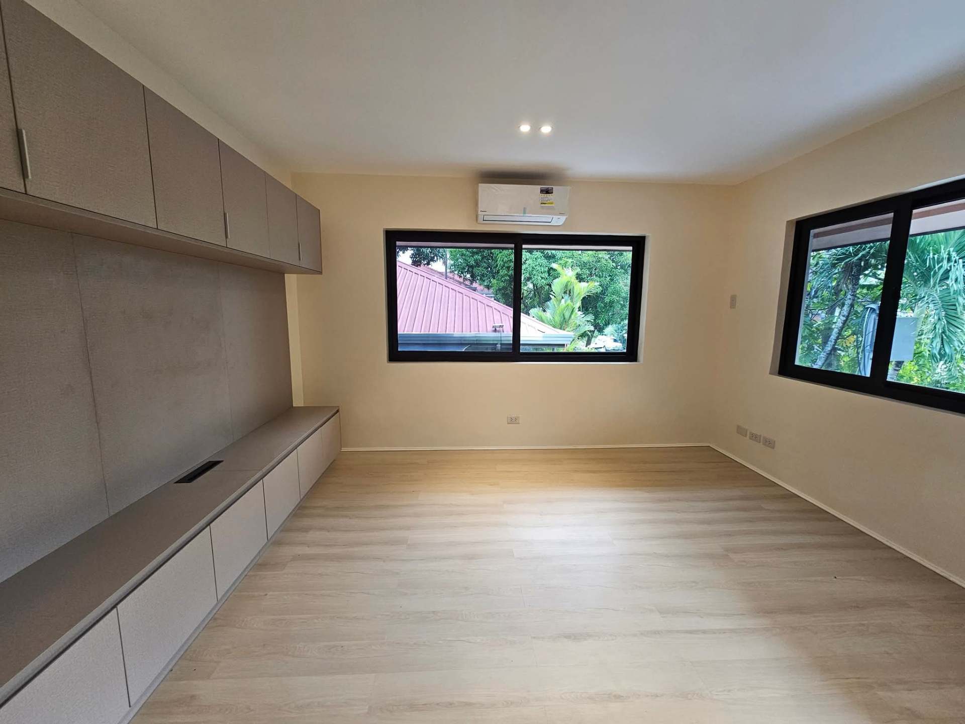 Bedroom with built-in cabinetry and herringbone-style flooring