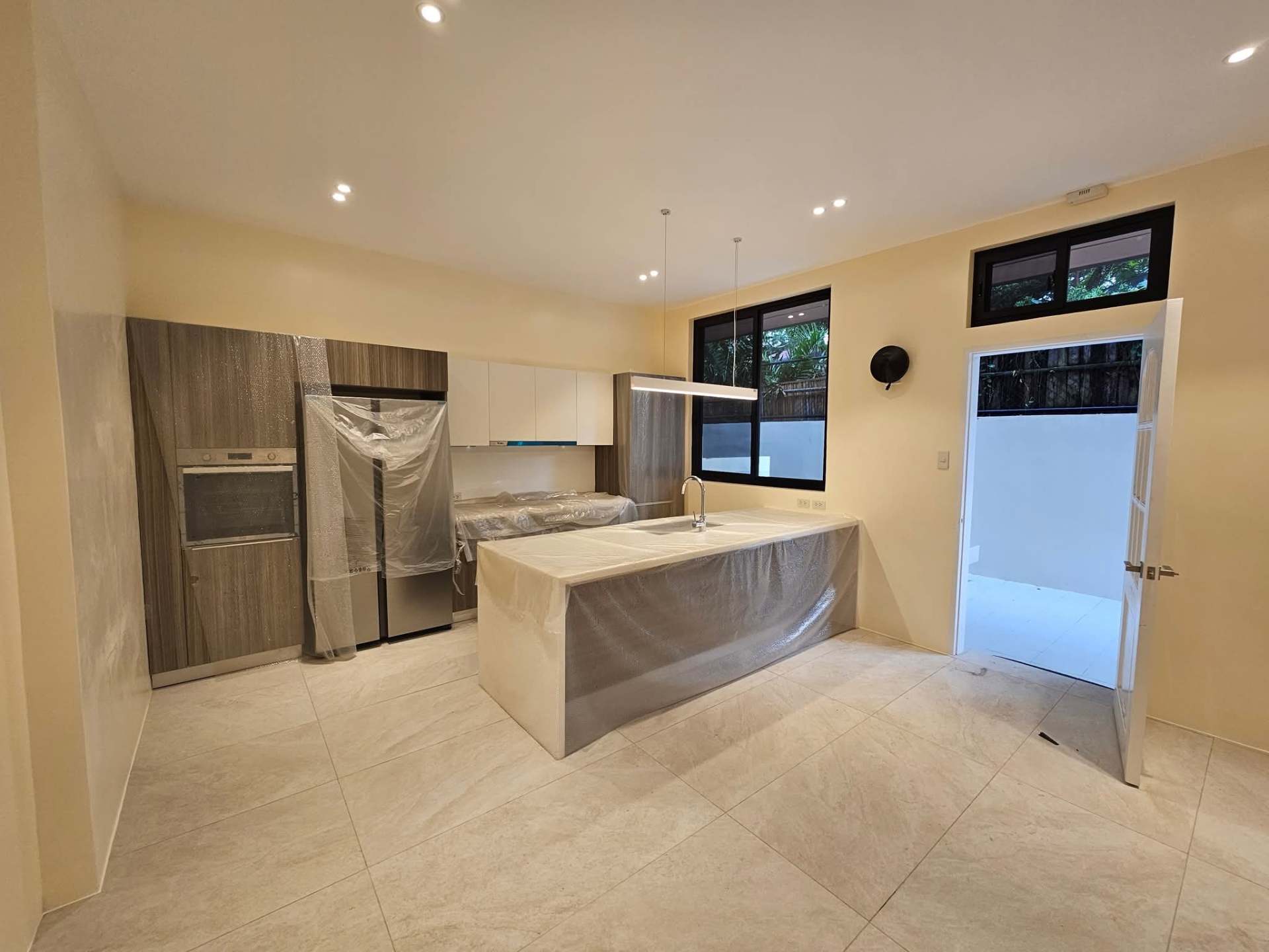 Service kitchen with built-in oven and prep island