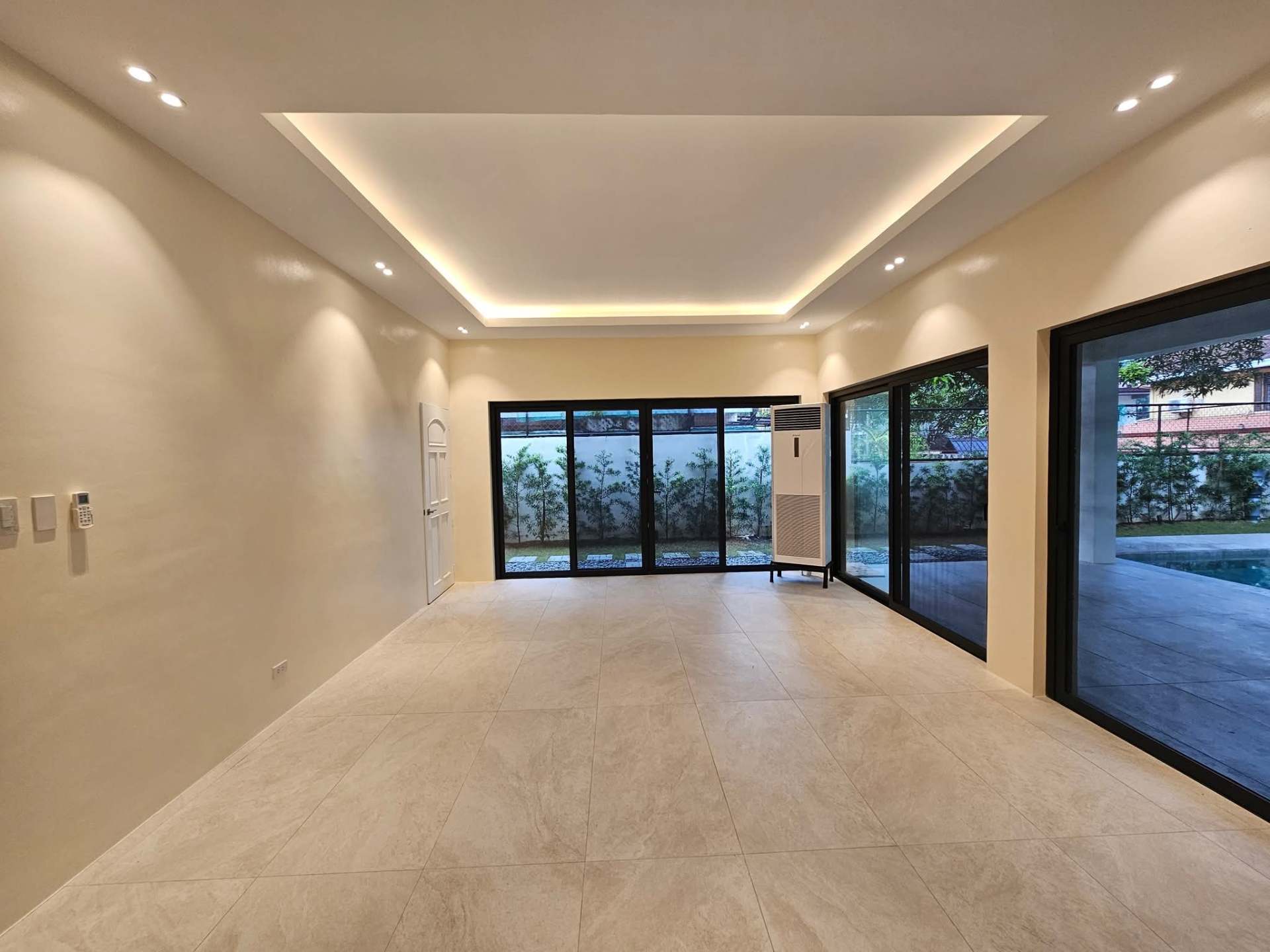Covered lanai with cove ceiling lighting opening to the garden