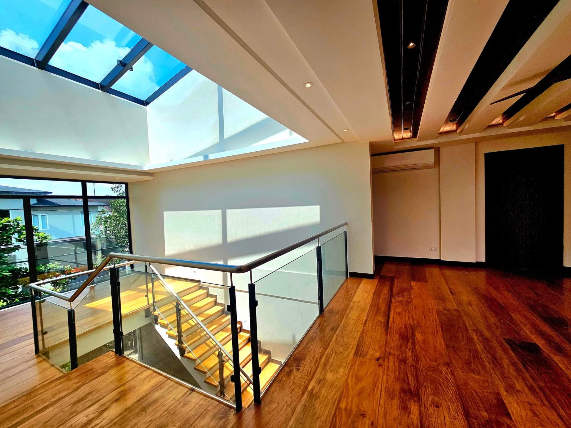 Upper landing with Narra wood floors and skylight overhead