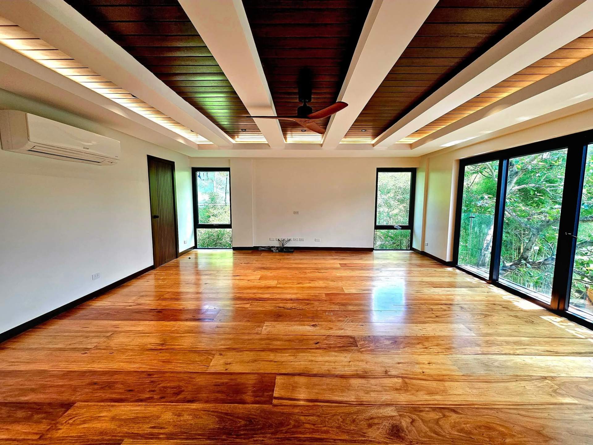 Living area with timber-beamed ceiling and Narra hardwood floors