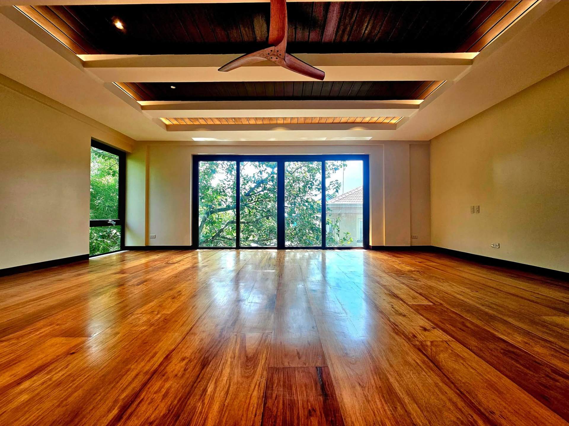 Master suite with coffered timber ceiling and garden views