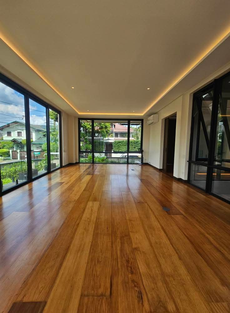 Living area with Narra wood floors and floor-to-ceiling glazing