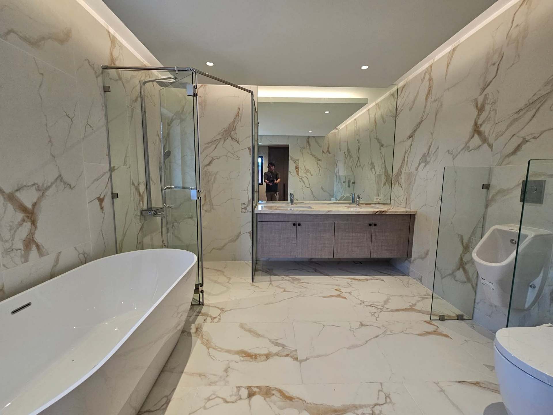 Master bath in book-matched marble with freestanding tub