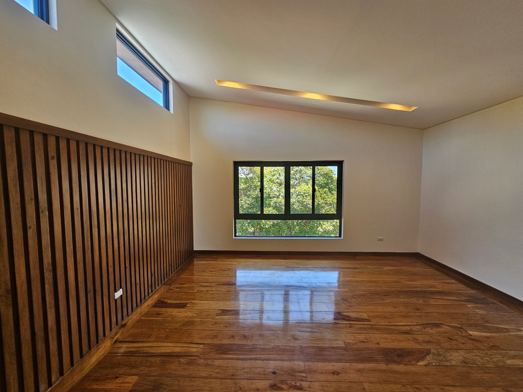 Bedroom with vaulted ceiling and timber slat feature wall