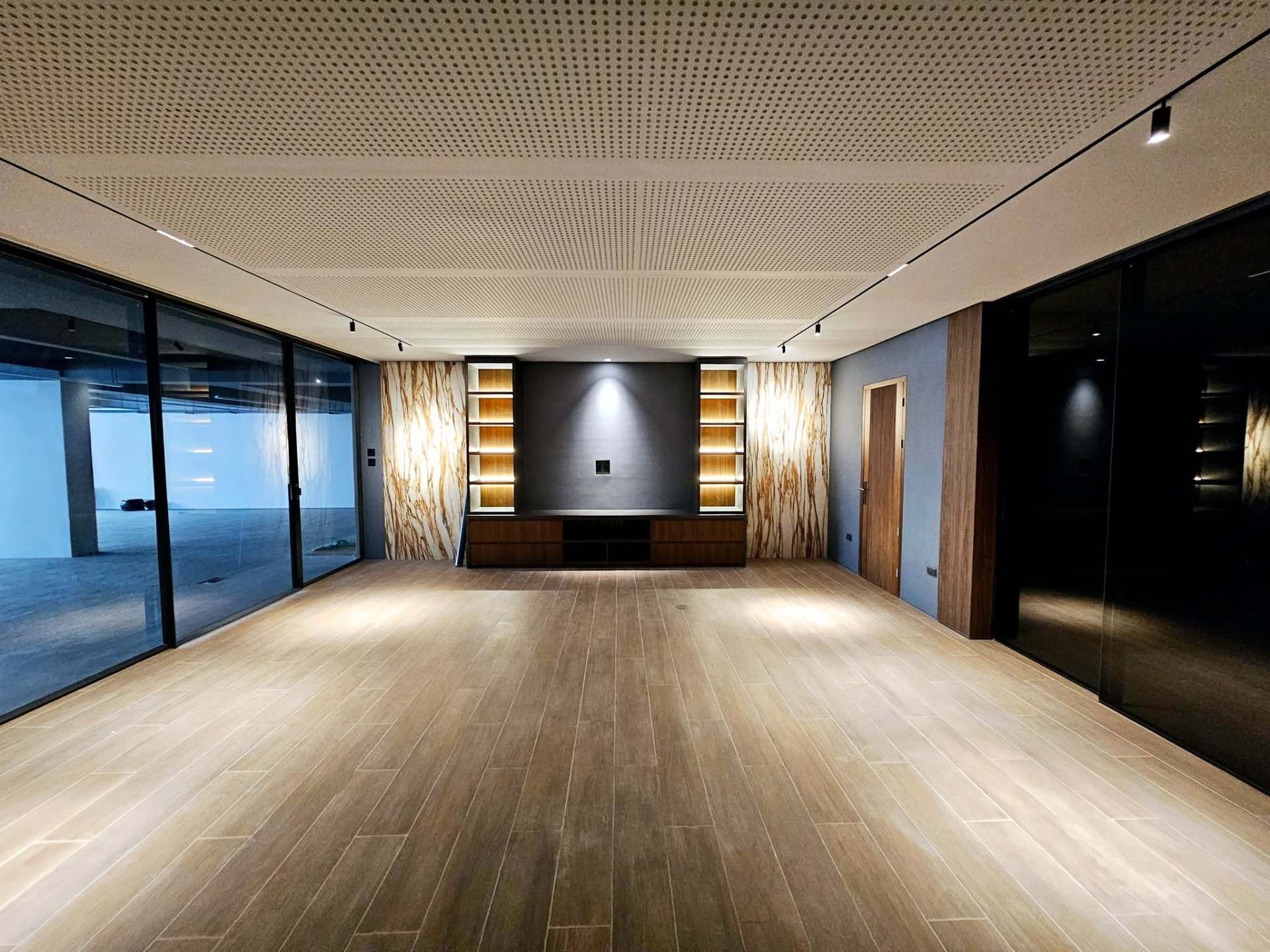 Attic entertainment area with onyx feature wall and timber floor