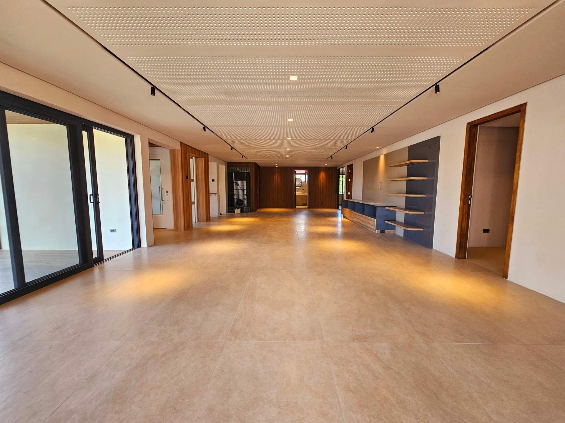 Vast formal living and dining hall with perforated acoustic ceiling