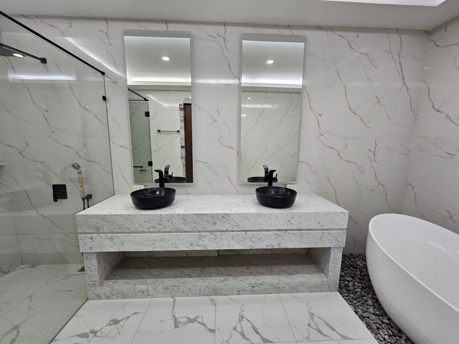 Master bath with twin black vessel sinks and double mirrors