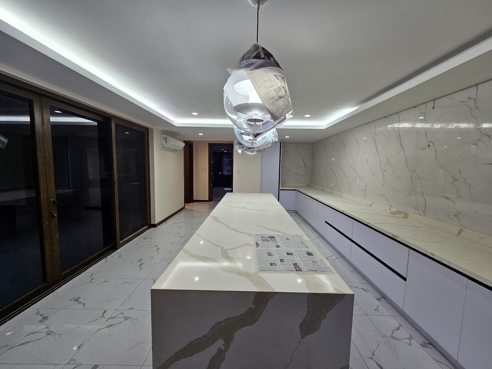 Showcase kitchen with marble backsplash and full-height glass doors