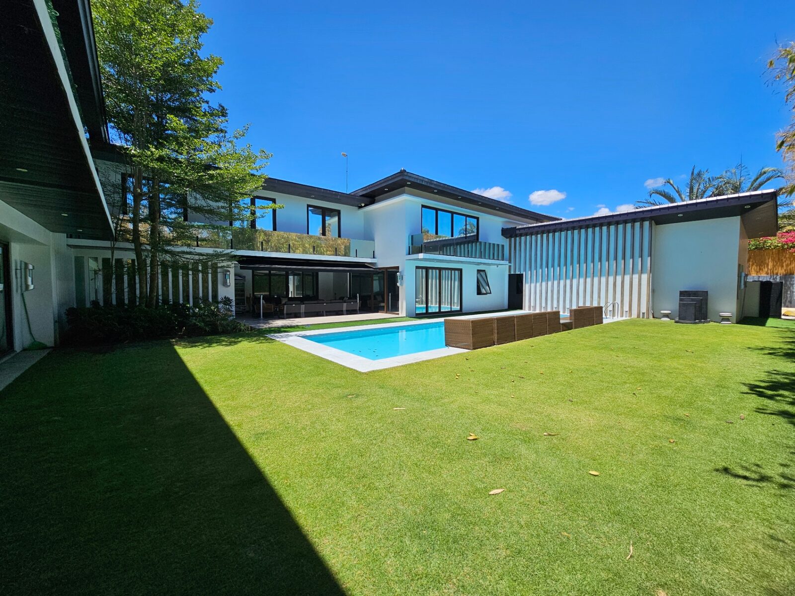 Rear elevation with swimming pool, lanai and expansive lawn