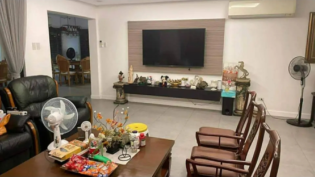 Family lounge with mounted TV, recliner sofas and adjacent dining
