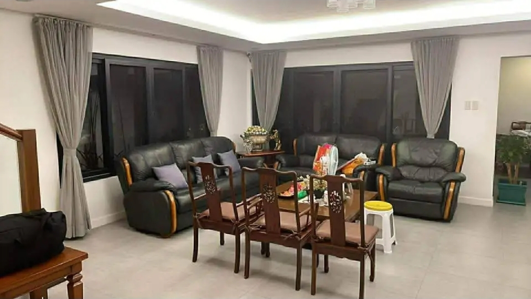 Spacious living and dining area with leather seating and wide windows