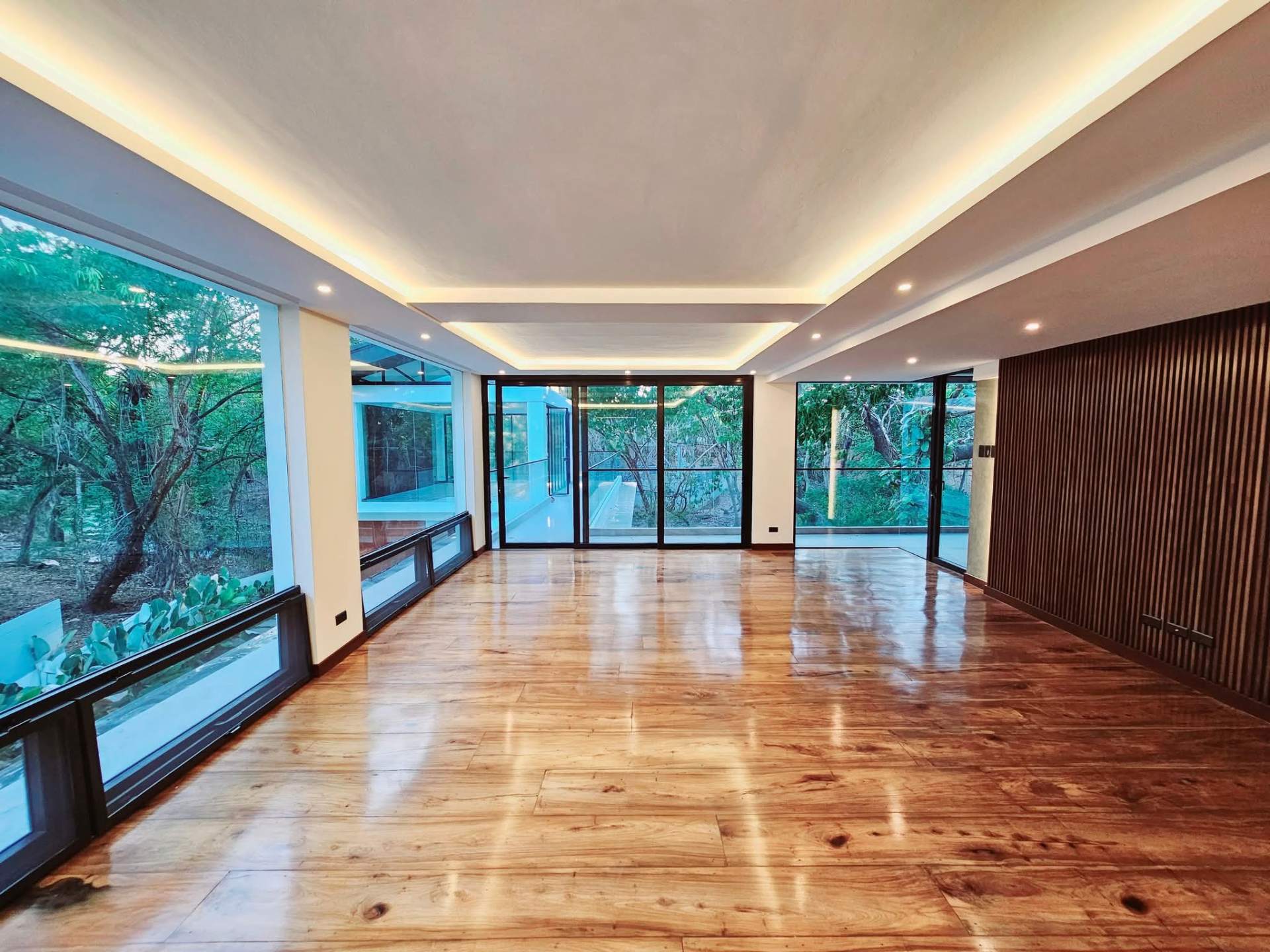 Upper floor with narra plank flooring and forest views