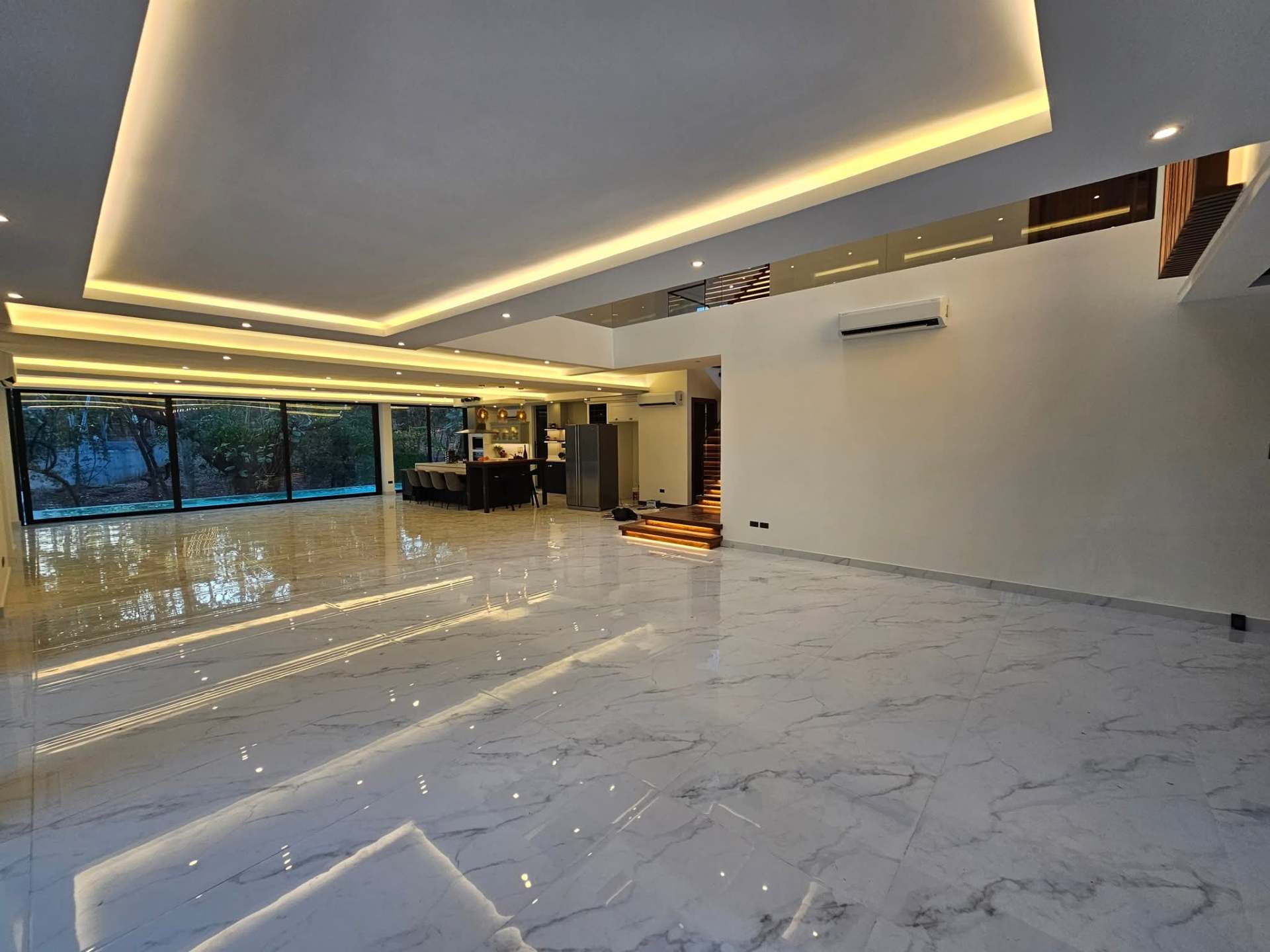 Expansive marble living hall with cove lighting