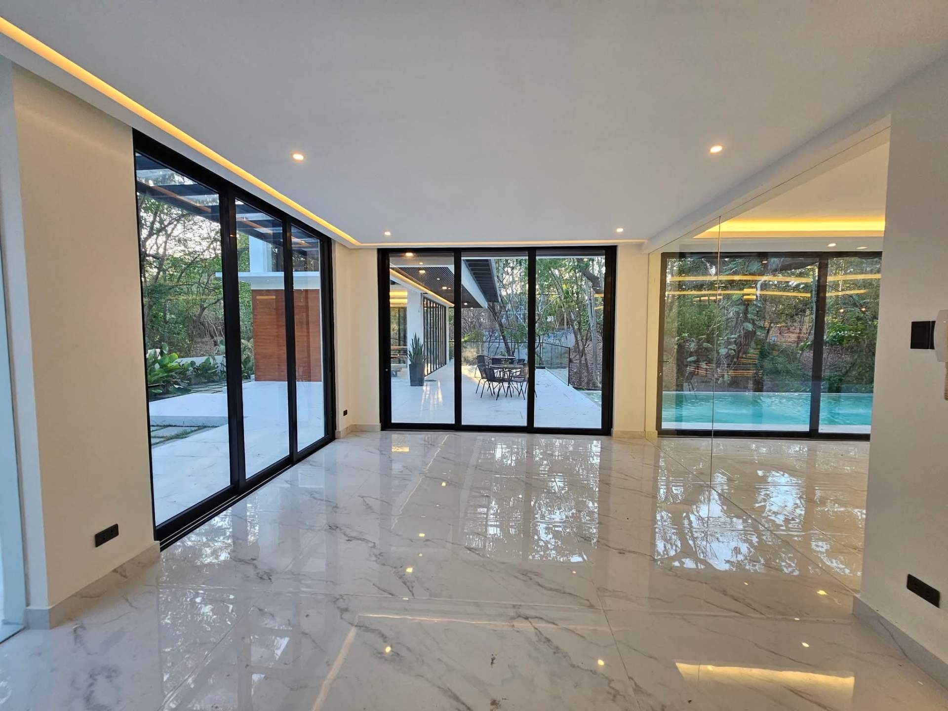 Glass-walled lounge opening to the pool deck