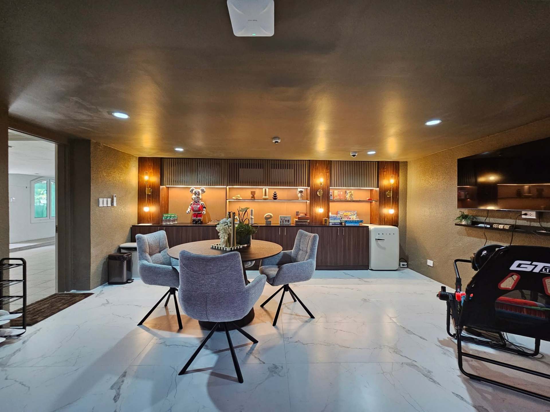 Family lounge / breakfast nook with marble floors and warm wood paneling